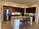Kitchen features dark wood cabinets, an island, and stainless steel appliances at 22455 N 55Th St, Phoenix, AZ 85054