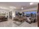Relaxing living room with a leather sectional sofa, large windows, and ceiling fan at 22455 N 55Th St, Phoenix, AZ 85054
