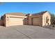 Two-car garage with tan stucco exterior and terracotta tile roof at 22455 N 55Th St, Phoenix, AZ 85054