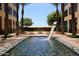 Relaxing courtyard with water feature, umbrellas, and seating at 22455 N 55Th St, Phoenix, AZ 85054
