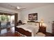 Main bedroom with king bed, hardwood floors, and access to a private patio at 22455 N 55Th St, Phoenix, AZ 85054