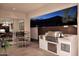 Outdoor kitchen with built-in grill and seating area at 22455 N 55Th St, Phoenix, AZ 85054