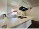 White kitchen with marble countertops and black appliances at 2814 N 55Th Ave, Phoenix, AZ 85035