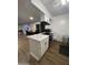 Kitchen with white cabinets, marble countertops and a breakfast bar at 2814 N 55Th Ave, Phoenix, AZ 85035