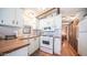 Bright kitchen with white cabinets, wood countertops, and appliances at 312 S Emerald Dr, Apache Junction, AZ 85119