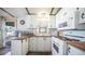Efficient kitchen with white cabinets and wood countertops at 312 S Emerald Dr, Apache Junction, AZ 85119