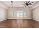 Bright living room featuring hardwood floors and a ceiling fan at 20618 W Elliot Rd, Buckeye, AZ 85326