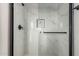 Modern shower with marble tile and black accents at 20618 W Elliot Rd, Buckeye, AZ 85326