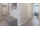 Bright entryway with tile flooring, bench, and views into adjacent rooms at 10538 W Quail Ave, Peoria, AZ 85382