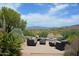 Relaxing patio with seating area and fire pit, offering scenic mountain views at 7435 E Sundance Trl # 403, Carefree, AZ 85377