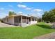 Tan house with a screened patio and grassy yard at 12563 W Brandywine Dr, Sun City West, AZ 85375