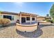 Covered patio with built-in grill and backyard access at 16682 W Pacheco Ct, Surprise, AZ 85387