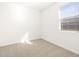 Well-lit bedroom featuring a window and carpet at 16028 W Hackamore Dr, Surprise, AZ 85387