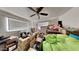 Bedroom with a ceiling fan, boxes, and a large green beanbag chair at 1701 W Highland Ave, Phoenix, AZ 85015