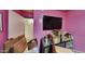 Bright bedroom with a large TV, currently being unpacked at 1701 W Highland Ave, Phoenix, AZ 85015