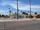 House with a large front yard and palm trees in a residential neighborhood at 1701 W Highland Ave, Phoenix, AZ 85015