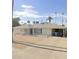 Ranch-style home with gravel driveway and palm trees at 1701 W Highland Ave, Phoenix, AZ 85015