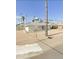 Ranch-style home with gravel driveway and palm trees at 1701 W Highland Ave, Phoenix, AZ 85015
