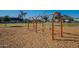 Traditional playground swings set in a sandy play area at 1701 W Highland Ave, Phoenix, AZ 85015