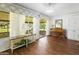 Bright sunroom with wicker furniture and view of the backyard at 9701 W Oak Ridge Dr, Sun City, AZ 85351