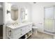 Bathroom features a double vanity with marble top, and large mirrors at 9701 W Oak Ridge Dr, Sun City, AZ 85351
