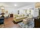 Living room with light beige couch and wood flooring at 9701 W Oak Ridge Dr, Sun City, AZ 85351