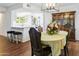 Dining room features hardwood floors and a lovely floral centerpiece at 9701 W Oak Ridge Dr, Sun City, AZ 85351