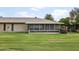 House exterior showcasing a screened patio and yard at 9701 W Oak Ridge Dr, Sun City, AZ 85351