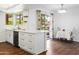 Modern white kitchen with stainless steel appliances and island at 9701 W Oak Ridge Dr, Sun City, AZ 85351