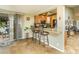 Kitchen with breakfast bar and view into adjacent living area at 1509 E Indian Wells Dr, Chandler, AZ 85249