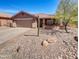Single-story home with two-car garage and desert landscaping at 563 S 230Th Ave, Buckeye, AZ 85326