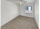 Bright bedroom with ceiling fan and carpeting at 563 S 230Th Ave, Buckeye, AZ 85326