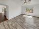Bright living room features wood-look tile floors and a view to the kitchen at 563 S 230Th Ave, Buckeye, AZ 85326