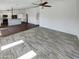Living room with view of kitchen and wood-look tile floors at 563 S 230Th Ave, Buckeye, AZ 85326