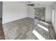 Living room with sliding door to backyard and wood-look tile at 563 S 230Th Ave, Buckeye, AZ 85326