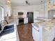 Modern kitchen with white cabinets, granite counters and black appliances at 563 S 230Th Ave, Buckeye, AZ 85326