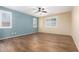 Bedroom with wood-look tile floors and neutral walls at 18514 W Statler St, Surprise, AZ 85388