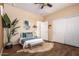 Bright bedroom with wood floors, a comfy bed, and ample closet space at 18514 W Statler St, Surprise, AZ 85388