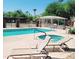 Relaxing community pool and spa with lounge chairs at 26 S Quinn Cir # 7, Mesa, AZ 85206
