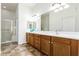 Double vanity bathroom with wood cabinets and tiled floor at 26 S Quinn Cir # 7, Mesa, AZ 85206