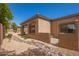 Landscaped backyard with rock pathway and wall at 26 S Quinn Cir # 7, Mesa, AZ 85206