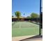 Community tennis court with surrounding fence at 26 S Quinn Cir # 7, Mesa, AZ 85206
