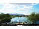 Stunning lakefront property with mountain backdrop and fire pit at 20620 N Confetti Ct, Maricopa, AZ 85138