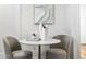 Small round table with two chairs in a bright, minimalist space at 4220 N 32Nd St # 4, Phoenix, AZ 85018