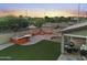 Entertaining backyard with built-in BBQ, fire pit and covered patio at 272 N 167Th Ln, Goodyear, AZ 85338
