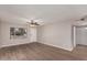 Bright living room featuring wood-look floors and a ceiling fan at 17226 N 29Th Dr, Phoenix, AZ 85053