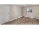 Bedroom with wood-look floors, window, and door at 17226 N 29Th Dr, Phoenix, AZ 85053