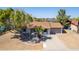 Single-story home with a brown roof and attached garage, nestled in a residential area at 17226 N 29Th Dr, Phoenix, AZ 85053