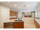 Well-equipped kitchen with island, wood cabinets, and tile floors at 15120 E Vermillion Dr, Fountain Hills, AZ 85268