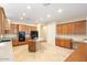 Spacious kitchen with wood cabinets, tile floors, and island at 15120 E Vermillion Dr, Fountain Hills, AZ 85268